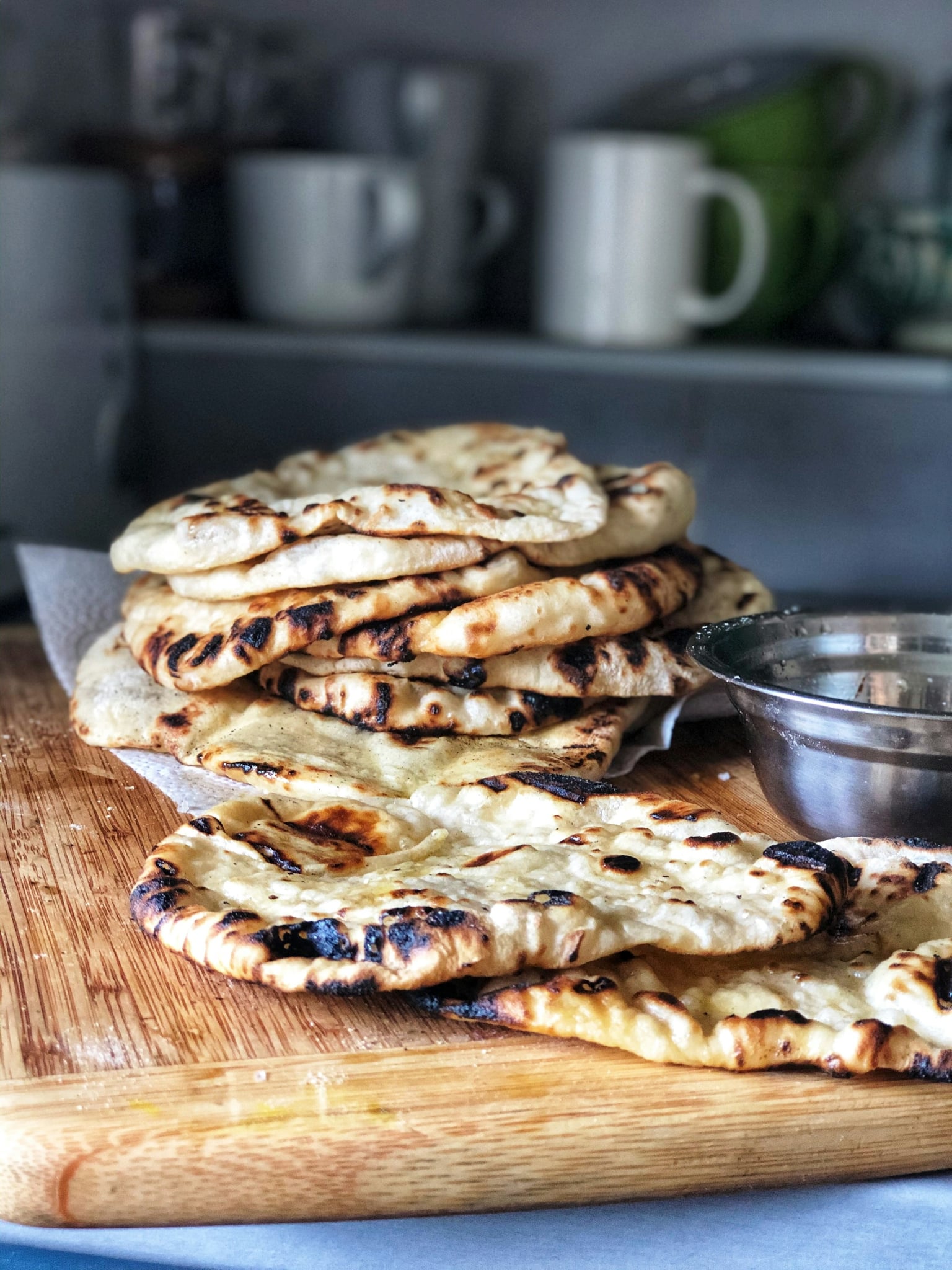 Stack of gas-fired flatbreads with charred edges
